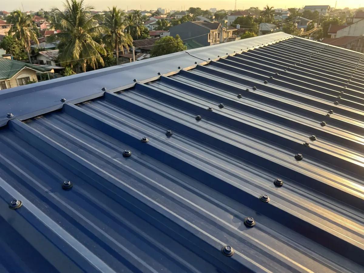New roofing sheets fastened with straight rows of screws with rubber washers